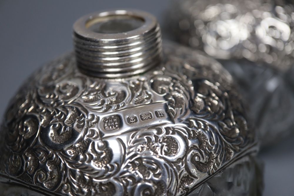A pair of Edwardian repousse silver-mounted globular glass scent bottles, J.H. Worrel, Son & Co Ltd, Birmingham, 1907